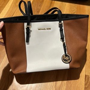 Gently used Michael Kors handbag. Black, white and tan with many pockets inside.